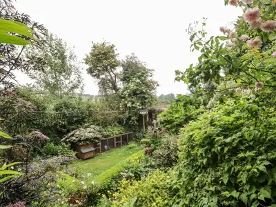 a garden with flowers and trees and a yard at Garden View in Kington