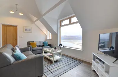 a living room with a couch and a tv at 2 Bed in Aberdyfi oc-wah694 in Aberdyfi