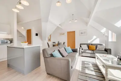 a living room with a couch and a table at 2 Bed in Aberdyfi oc-wah694 in Aberdyfi