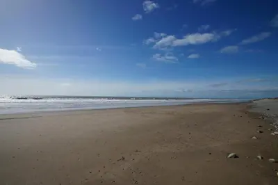 an empty beach with the ocean in the background at 2 Bed in Barmouth oc-wah698 in Talybont