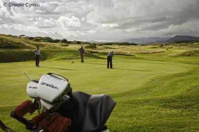 a group of people playing golf on a golf course at 2 Bed in Barmouth oc-wah698 in Talybont