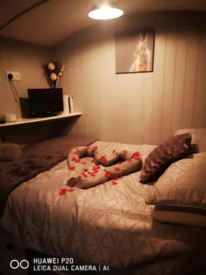 a person laying on a bed with blood on it at pen-rhos luxury glamping 