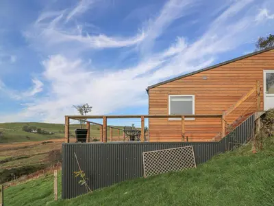 a house on a hill with a deck at Haka Lodge in Aberystwyth