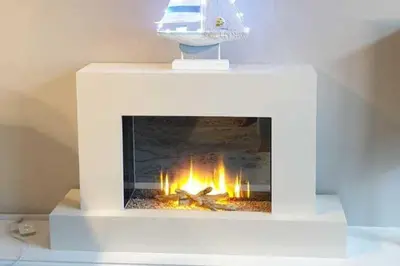 a white fireplace with a fire in it at Seaview Apartment Sleeps 2 -Patio -WiFi -Tv in Barmouth