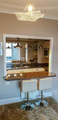 a kitchen with a counter and a sink and a mirror at Seaview Apartment Sleeps 2 -Patio -WiFi -Tv in Barmouth