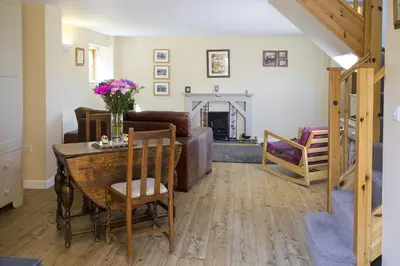 a living room with a table and a couch at Finest Retreats - 1 Bed Llangollen Cottage - Sleeps 2 in Llangollen