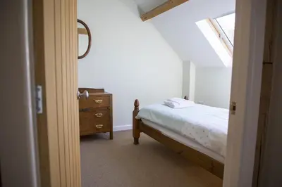 a bedroom with a bed and a dresser and a window at Finest Retreats - 2 Bed Llangollen Cottage - Sleeps 4 in Llangollen