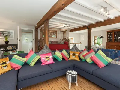 a blue couch with colorful pillows on it at Rhydleos Mill in Llansilin
