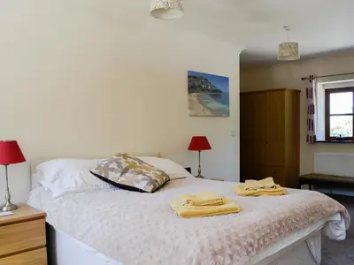 a bedroom with a bed with two towels on it at Ty Cregyn - Uk11957 in New Quay