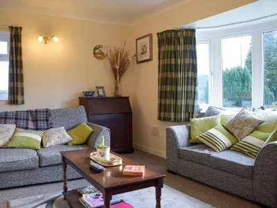 a living room with two couches and a table at Kinverley in Evenjobb