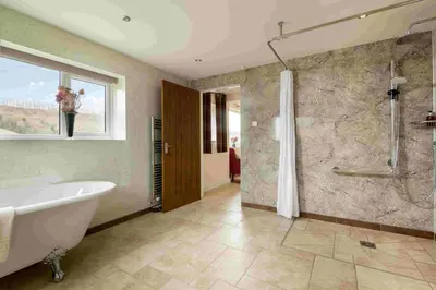 a large bathroom with a tub and a shower at Pendennis at Eaton Manor in Church Stretton