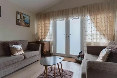 a living room with a couch and a table at Chalet Kiss of the Sea in Aberystwyth