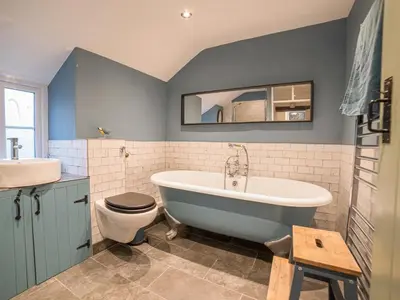a bathroom with a tub and a toilet and a sink at Bwthyn Dyfi in Machynlleth