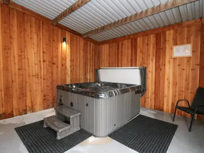 a wood paneled room with a stove in it at Y Felin - Celyn in Borth