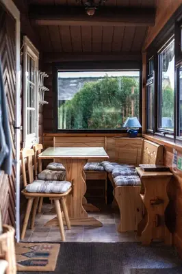 a room with a table and chairs and a window at Log Cabin nr Coed y brenin By Seren Short Stays in Trawsfynydd