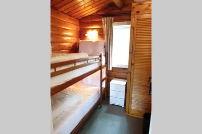 a bedroom with two bunk beds in a wooden cabin at Log Cabin nr Coed y brenin By Seren Short Stays in Trawsfynydd