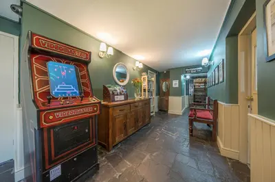 a room with a video game console and a television at The Boars Head Pub in Bishops Castle
