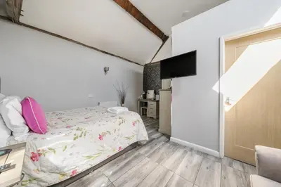 a bedroom with a bed and a flat screen tv at The Boars Head Pub in Bishops Castle