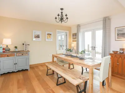 a dining room with a wooden table and chairs at Red Ridge in Harlech
