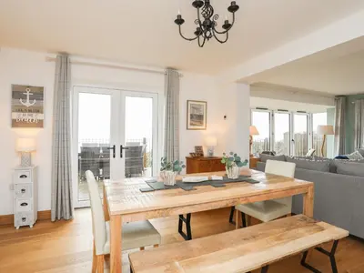 a living room with a wooden table and a couch at Red Ridge in Harlech