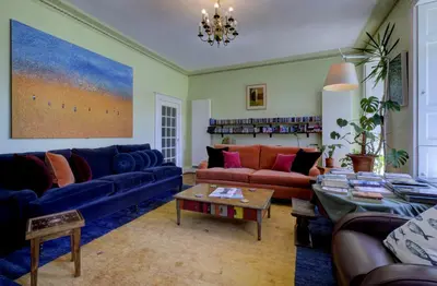 a living room with couches and a table at Borthwnog Hall in Dolgellau