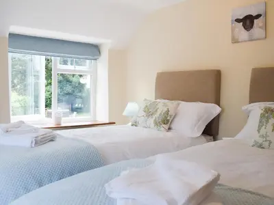 two beds in a room with a window at Herrock View in Evenjobb
