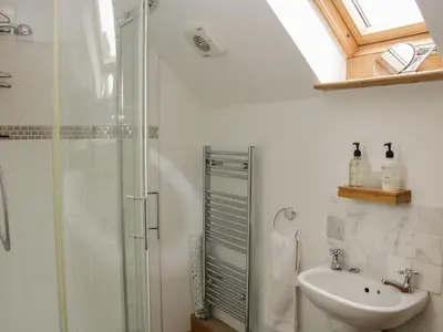 a bathroom with a shower and a sink at Minton Lane Cottage in Church Stretton