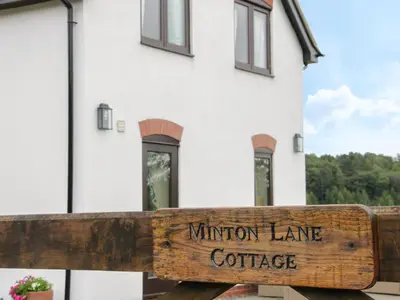 a wooden sign for the million lane coffee house at Minton Lane Cottage in Church Stretton