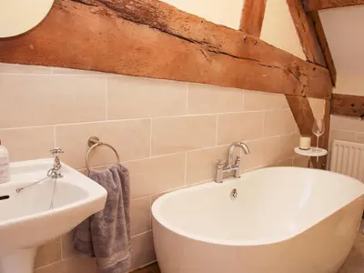 a bathroom with a sink and a bath tub at Broughton Stables in Montgomery