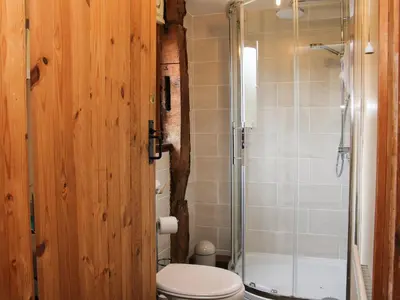 a bathroom with a toilet and a shower at Broughton Stables in Montgomery