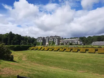 a large house on top of a green field at The Rhiw in Newtown