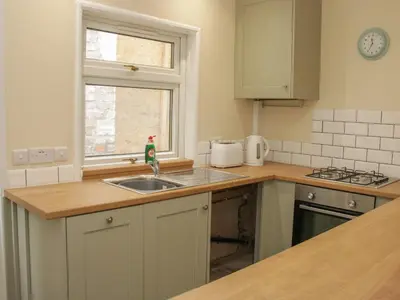 a kitchen with a sink and a window at Whitewater Cottage in Llangollen