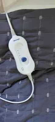 a white toothbrush sitting on top of a blanket at The Holt in Llangollen