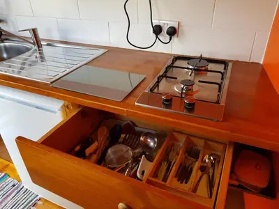 a kitchen with a stove and a drawer with utensils at Cozy Cabin Retreat - Sleeps 2 & a Child in Craven Arms