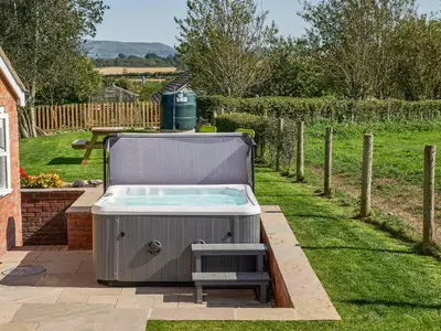 a hot tub sitting in the grass in a yard at Conquer Hall in Montgomery