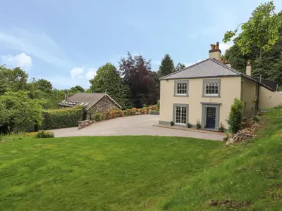 a house on a hill with a driveway at Cwmalis Hall in Llangollen