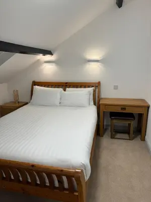 a bedroom with a bed and two nightstands and a bed sidx sidx sidx at The Radnorshire Arms Hotel in Presteigne