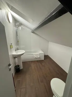 a bathroom with a sink and a tub and a toilet at The Radnorshire Arms Hotel in Presteigne