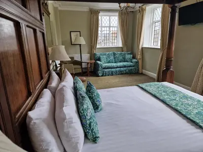 a bedroom with a bed with pillows on it at The Radnorshire Arms Hotel in Presteigne