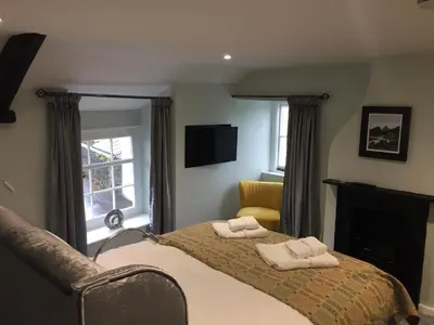 a bedroom with a bed with two towels on it at Mount Street House in Brecon
