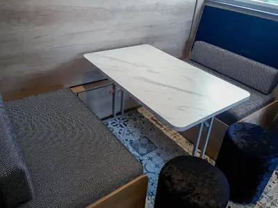 a table and two chairs in a train room at Lake Vyrnwy Luxury Pod in Llanwddyn