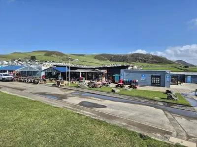 a street with a town with a building and grass at Hill View caravans in Aberystwyth