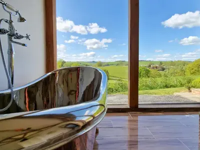 a chair sitting in front of a window with a view at Oak View in Highgate