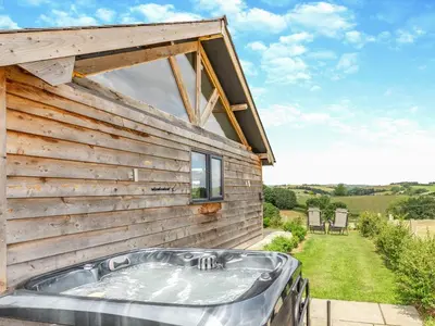 a hot tub on the side of a house at Oak View in Highgate