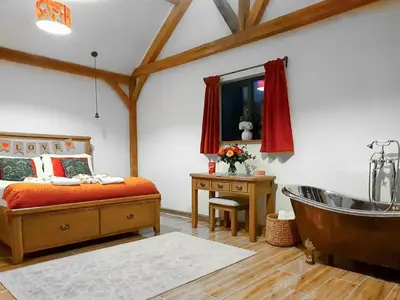 a bedroom with a bed and a bath tub at Oak View in Highgate