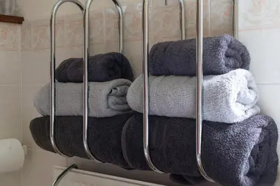 a bunch of towels hanging on a rack in a bathroom at Finest Retreats - The Grove Annexe in Craven Arms