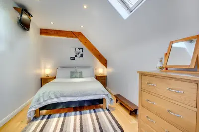 a bedroom with a bed and a dresser at 3 Bed in Tywyn oc-bow170 in Tywyn