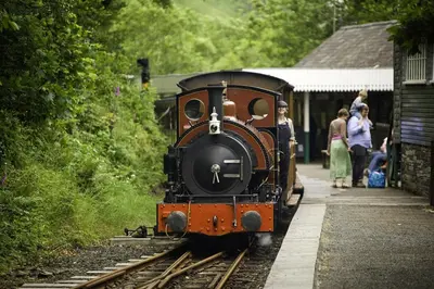 a train pulling into a train station with people on it at 3 Bed in Tywyn oc-bow170 in Tywyn