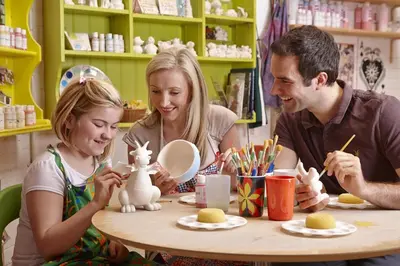 a family playing with a toy rabbit at a table at 3 Bed in Tywyn oc-bow170 in Tywyn
