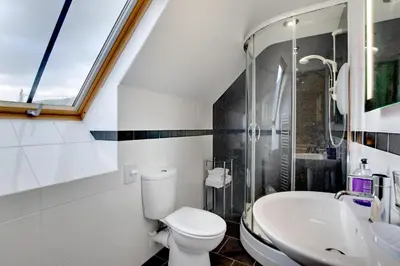 a bathroom with a toilet and a sink at 3 Bed in Tywyn oc-bow170 in Tywyn